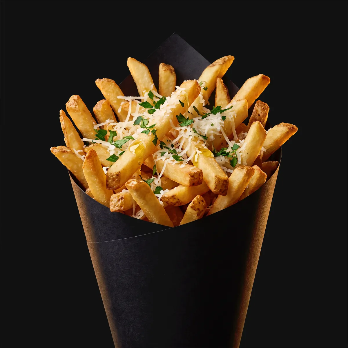 Parmesan fries piled high in a black paper cone.